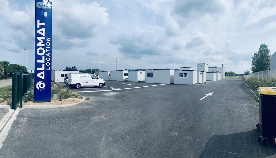 Entrée du site Allomat Location avec des dizaines de modules de bureau chantier en stock.
